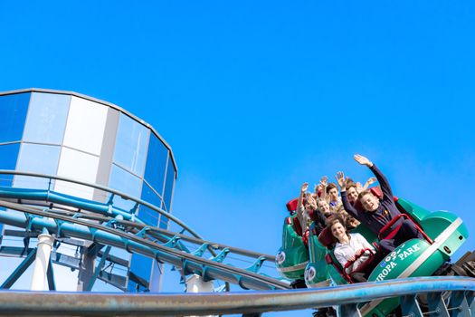 People enjoying a thrilling roller coaster ride at Europa-Park on a sunny day.