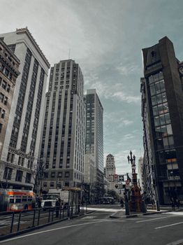 Downtown San Francisco cityscape featuring tall skyscrapers and a bustling street scene on a clear day.