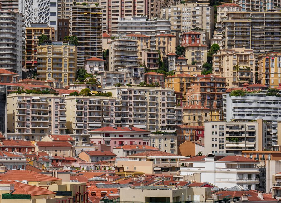 Experience the colorful and densely packed urban architecture of Monaco in this stunning cityscape photo.