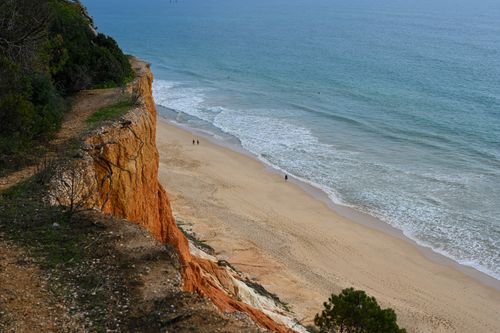 Free Dramatic cliffs overlooking the beautiful beaches of Faro, Portugal. Stock Photo