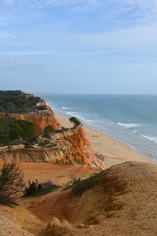 Free Breathtaking view of Algarve's red cliffs and turquoise ocean, perfect for nature lovers. Stock Photo
