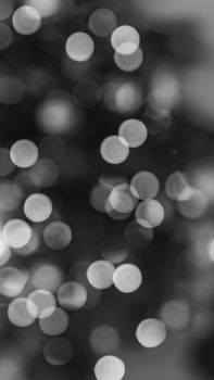 Elegant black and white bokeh effect creating an abstract light pattern for artistic backgrounds.