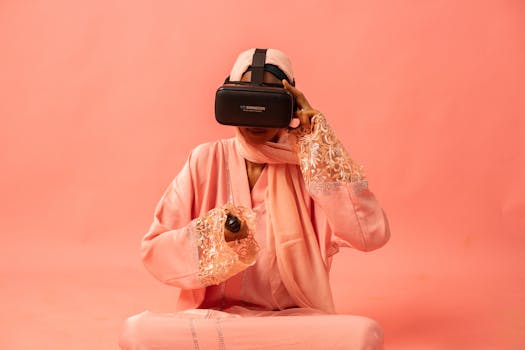Woman in pink traditional clothing using a VR headset against a pink backdrop.