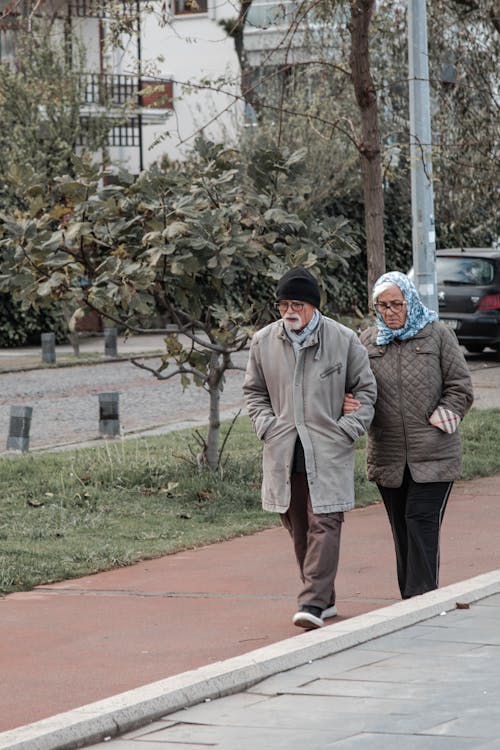 Elderly Couple Walking on a Street