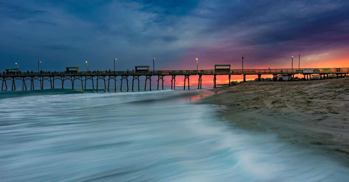 A breathtaking view of Emerald Isle Pier in North Carolina, captured at dusk with long exposure.