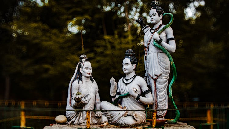 Close-up Of Religious Sculptures In A Garden 