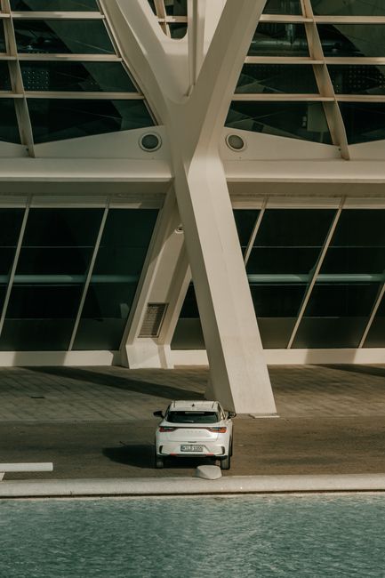Stylish structure with a modern car parked, showcasing contemporary architecture.