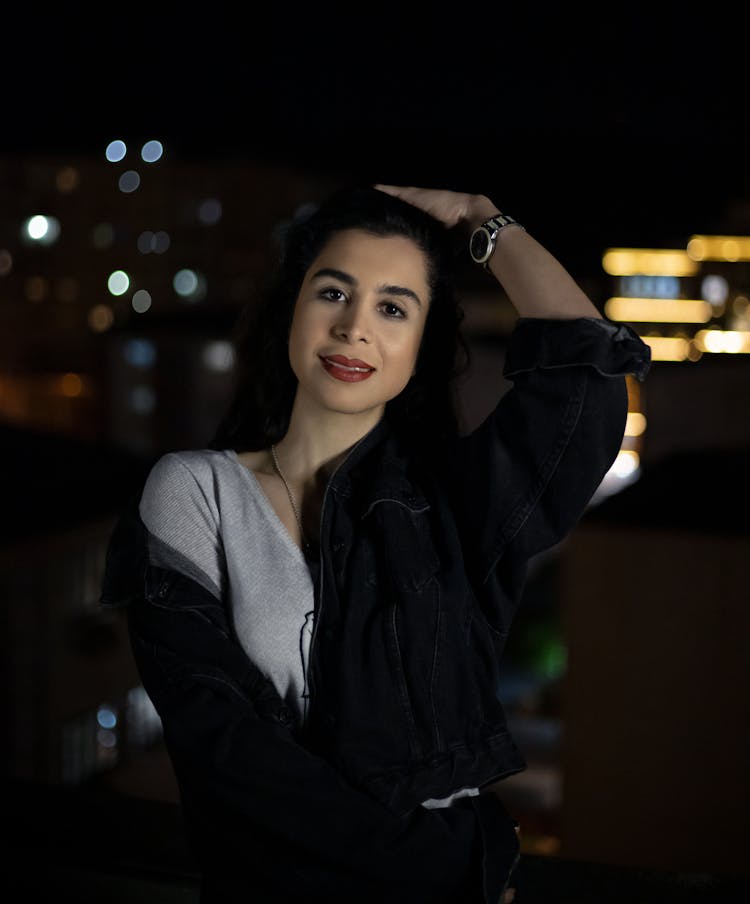 Young Woman Standing Outside With Hand In Hair 