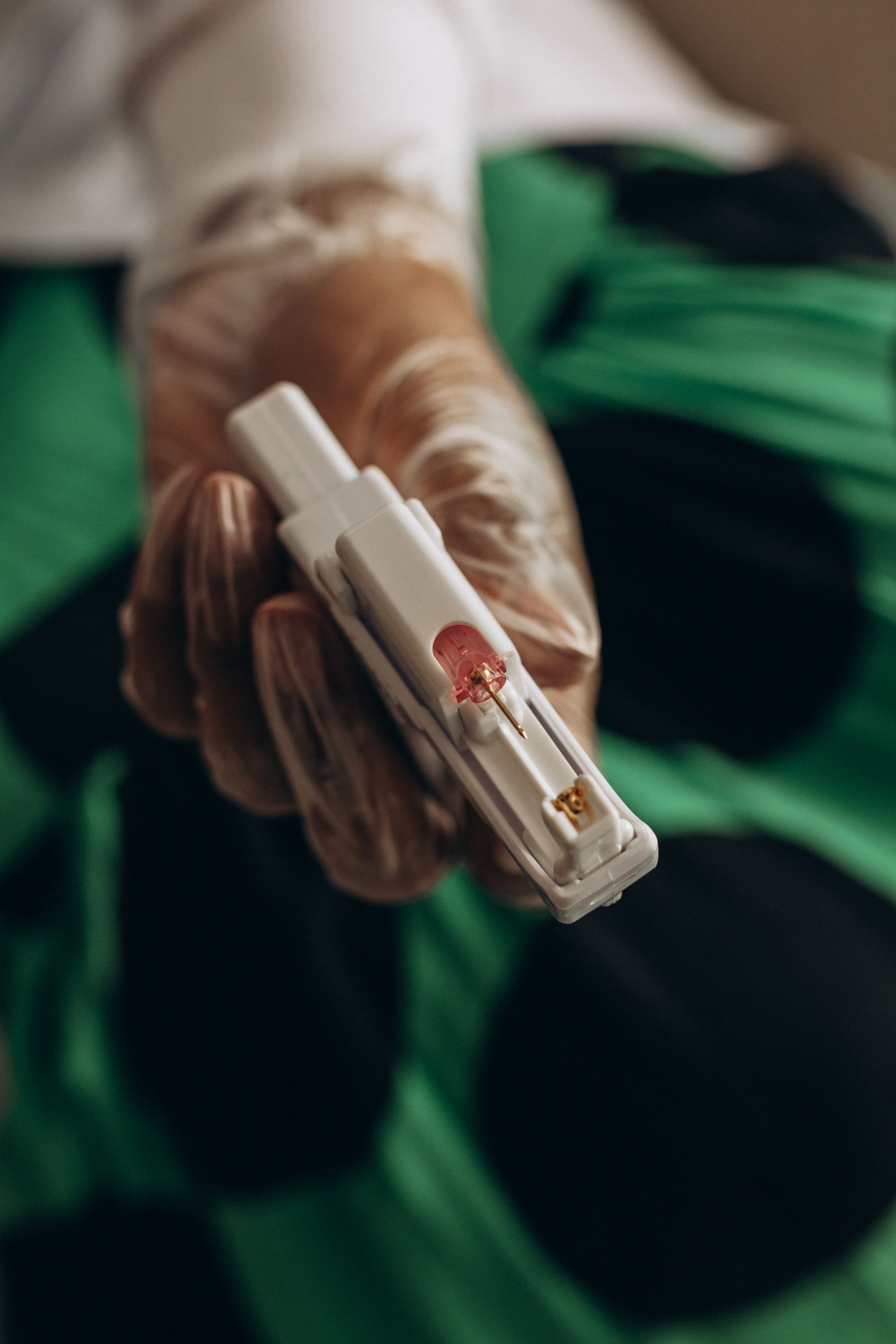 Representative compact blood-testing device held by a healthcare professional