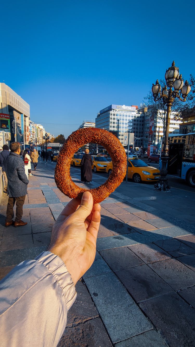 Hand Holding Simit In Town In Turkey