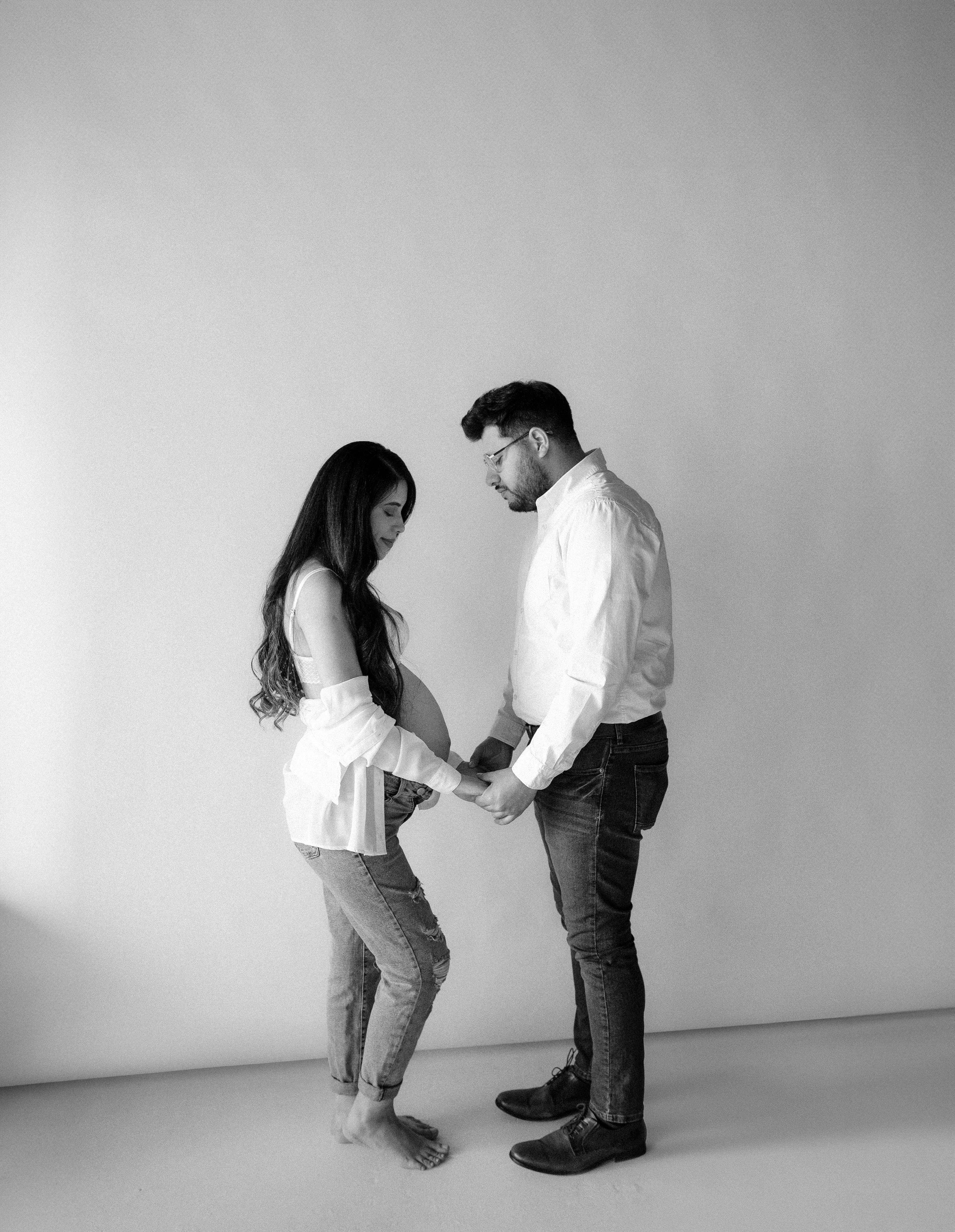 Premium Photo | Portrait of young couple in love posing at studio dressed  in classic clothes