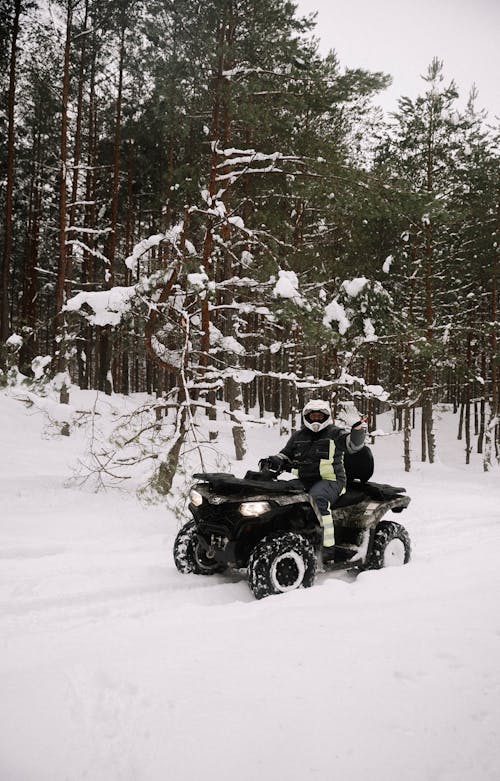 Man on Quad in Winter Forest