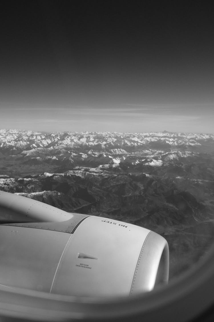 Airplane Engine And Mountains Behind In Black And White