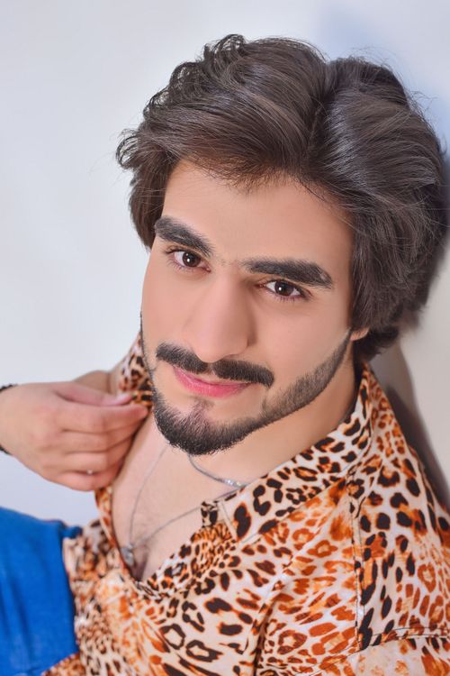 Free Close-up portrait of a man with short hair wearing a leopard print shirt, posing in a fashion style. Stock Photo