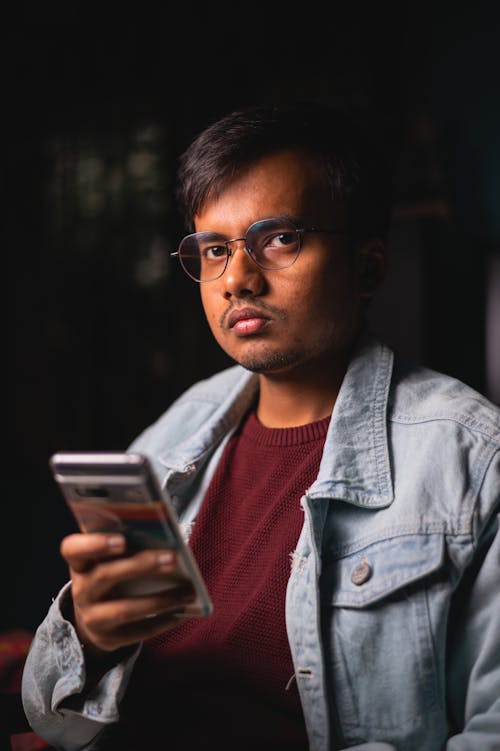 Man in Jean Shirt with Smartphone