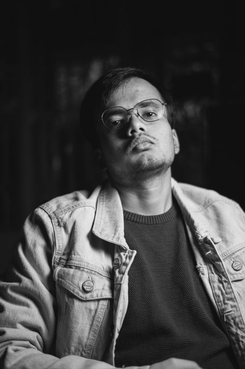 Free Artistic black and white portrait of a man wearing denim jacket with a serious expression. Stock Photo