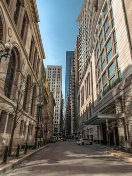 Cityscape of a downtown Chicago street flanked by tall buildings under a clear sky.