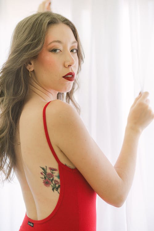 Model in a Red Backless Dress with a Flower Tattoo