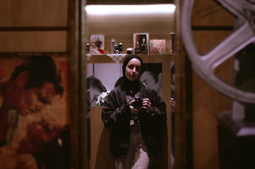 Portrait of a Young Woman Wearing a Hijab Holding a Camera
