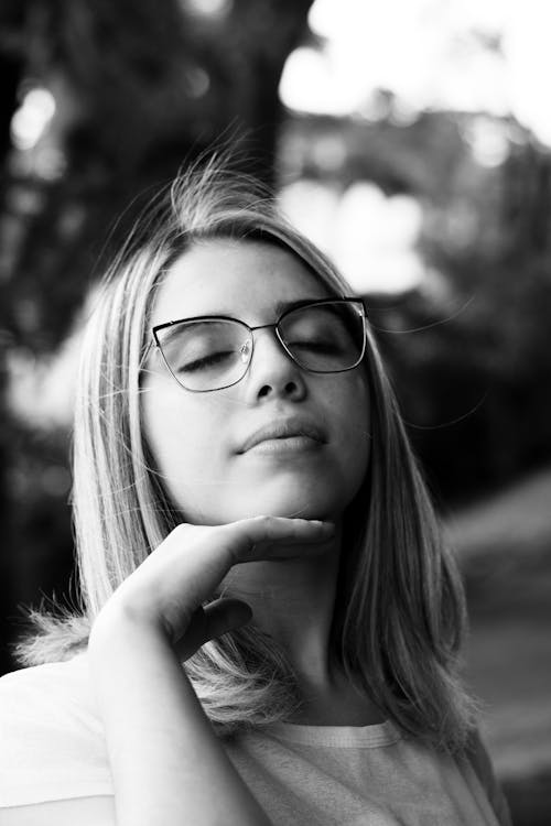 Black and White Photo of a Woman with her Eyes Closed 