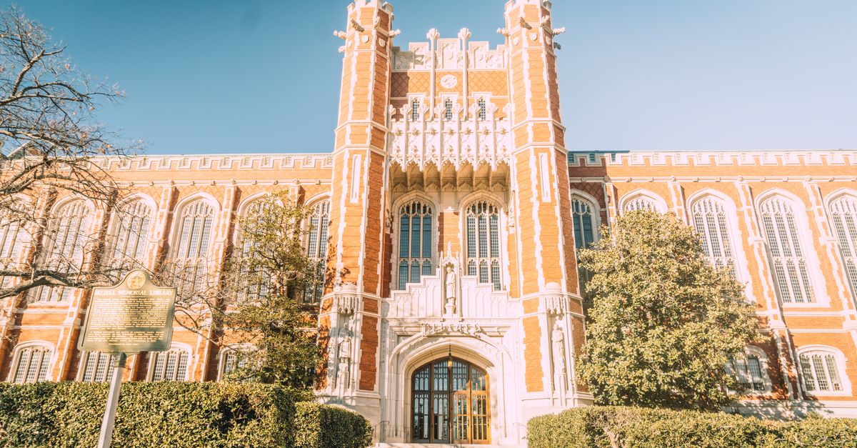 Beautiful Neo-Gothic architecture of the University of Oklahoma under a clear sky.