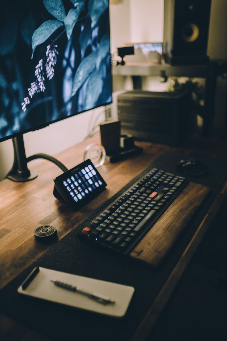 A stylish and tech-savvy desk setup featuring a keyboard and monitor with a digital tablet.