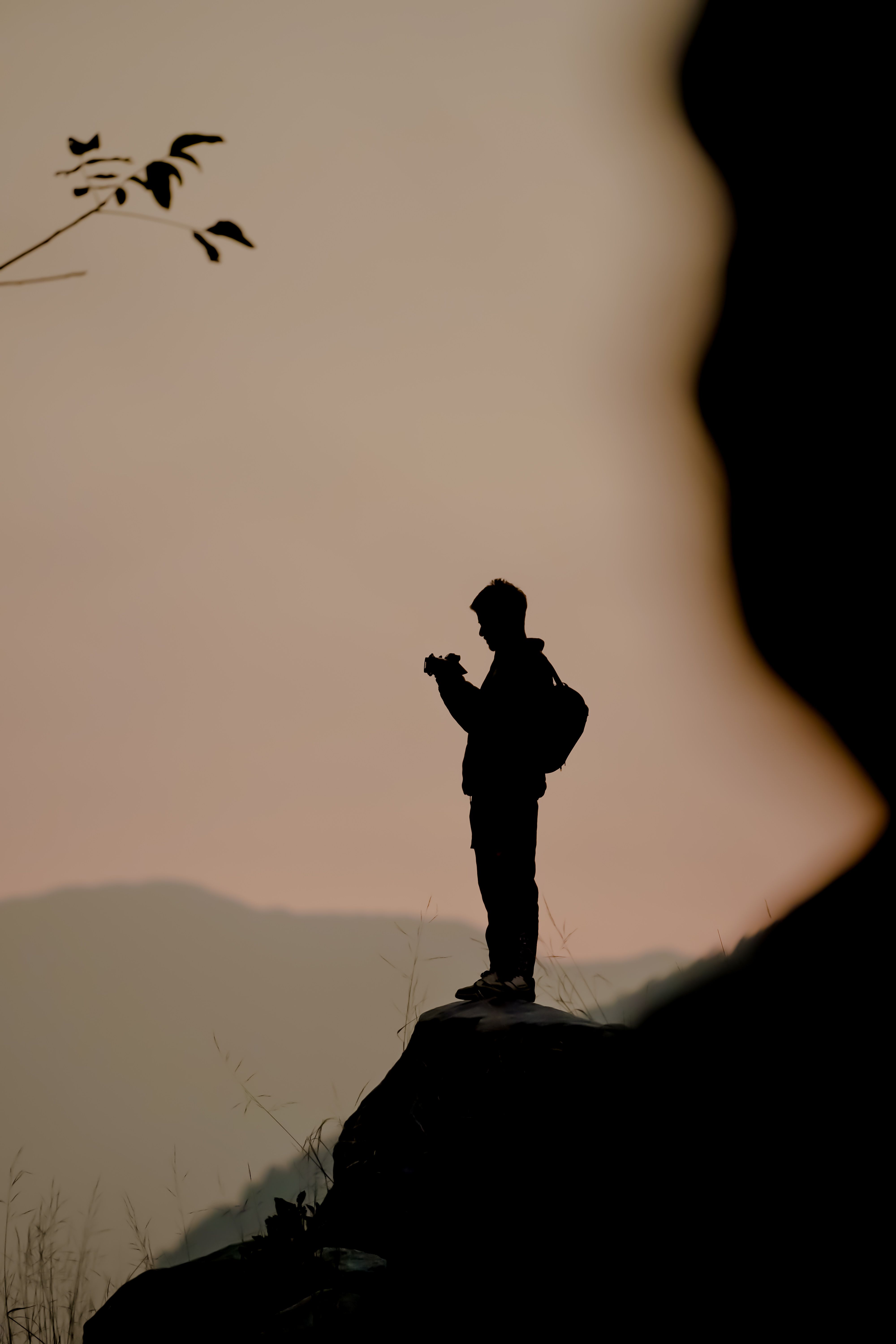 Silhouette of a Man Standing on the Mountain Edge · Free Stock Photo