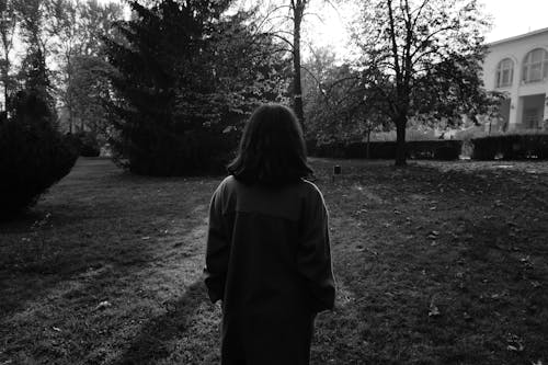Woman Standing in Garden in Autumn