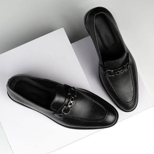 Free Stylish black leather loafers with chrome detail, perfect for formal occasions. Stock Photo