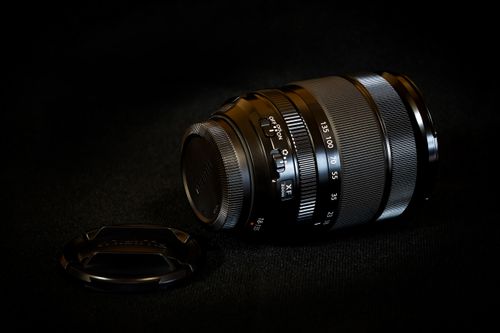 Free Detailed close-up of a camera lens on a dark background, showcasing professional photography equipment. Stock Photo