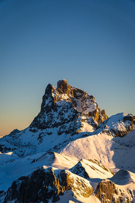 Scenic view of the majestic snow-covered Pic du Midi d'Ossau during sunset in the Pyrenees, France.