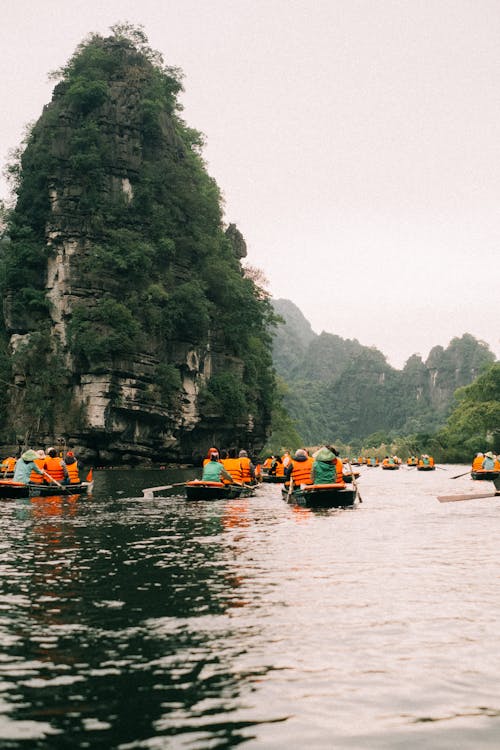 People Boating among Rock Formations