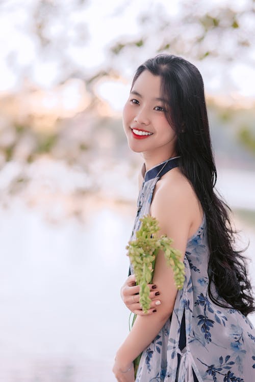 Brunette Wearing a Dress, Posing with a Plant