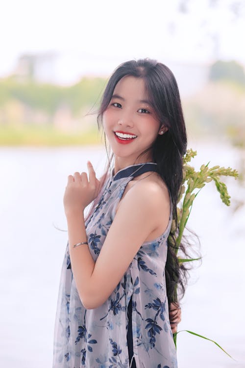 Brunette Wearing a Dress, Posing with a Plant