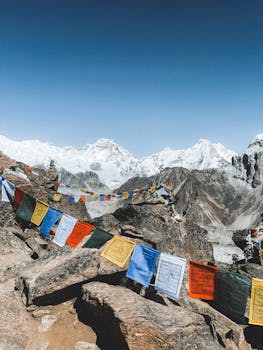 Vibrant prayer flags flutter amidst the majestic Himalayan mountains in Nepal.