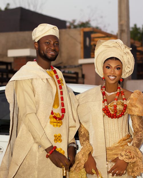 Photo of a Man and a Woman Wearing Traditional Clothing with Turbans