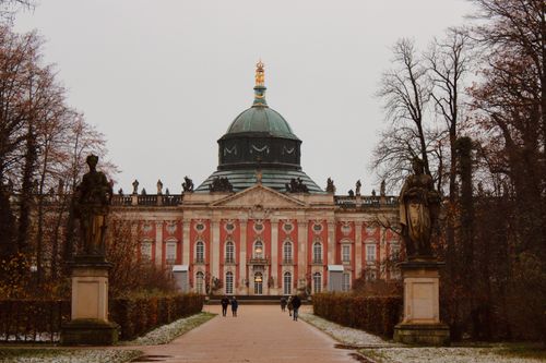 Free A majestic view of the New Palace in Potsdam with statues and trees lining the path in winter. Stock Photo