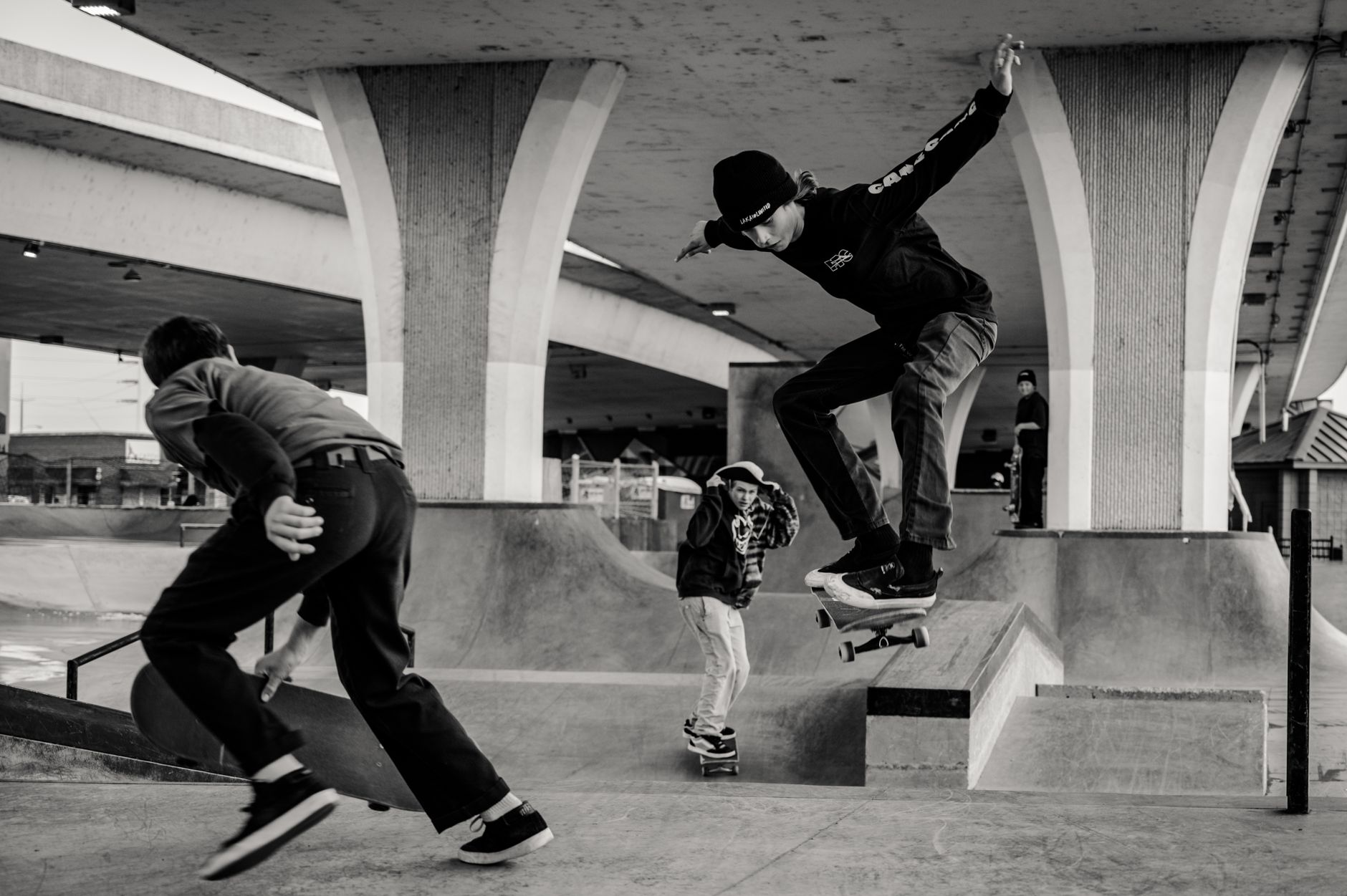 Archival skate zines, Houston street maps, and handwritten brand notes arranged on a wooden research table
