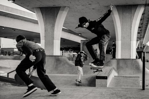 Monochrome Photo of Men Skateboarding