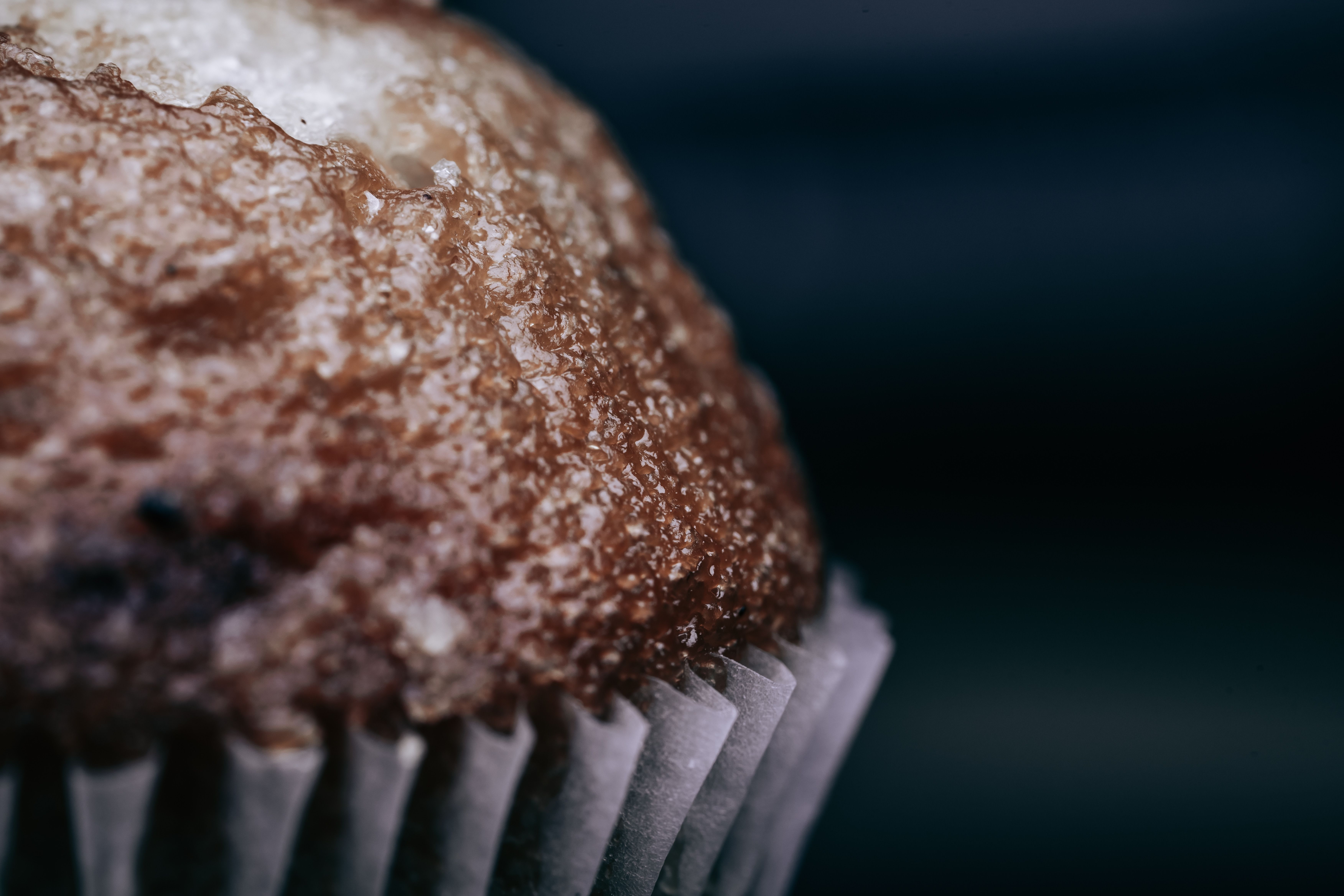 Delicious close-up of a sugary muffin highlighting texture and detail.