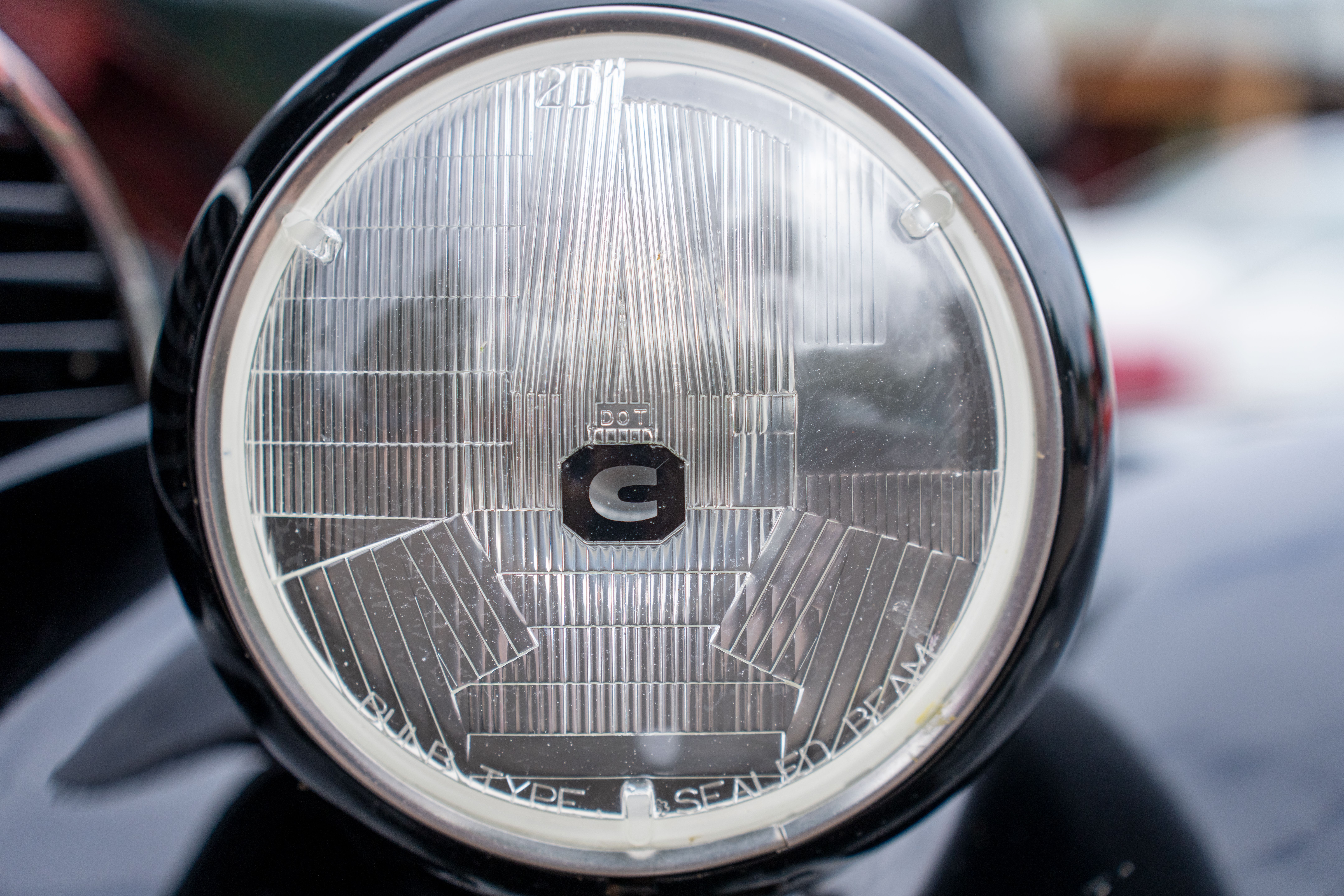 Close-up vintage car headlight showcasing classic automotive design in Nelson, WI.