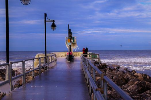 A person walking on a pier at night