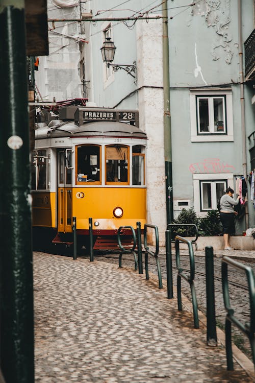 Historic Tram 28 on a Narrow Alley in Lisbon