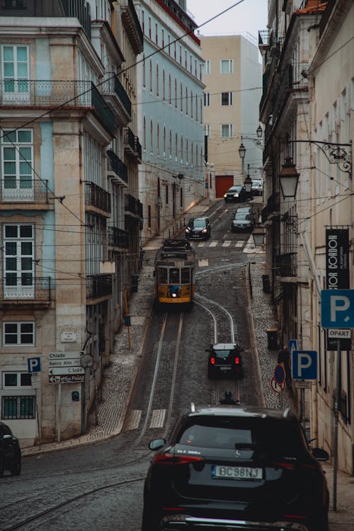 Cars and Tram in Narrow Alley in Lisbon, Portugal