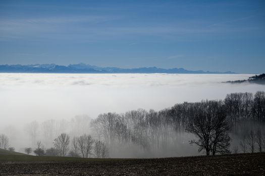 A view of the mountains and fog covered valley