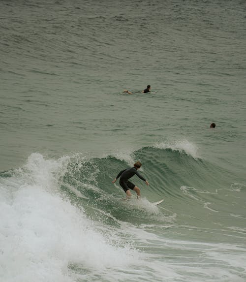 View of People Surfing on the Sea 
