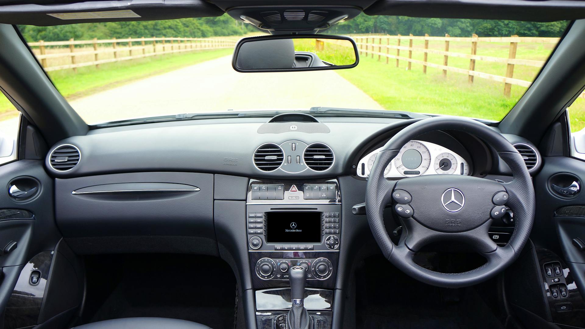 Explore the sleek design of a luxury Mercedes-Benz car interior with a focus on the dashboard and steering wheel.