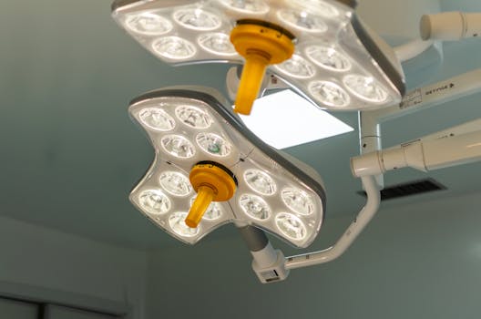 Bright LED surgical lights in a hospital operating room, emphasizing technology and healthcare.
