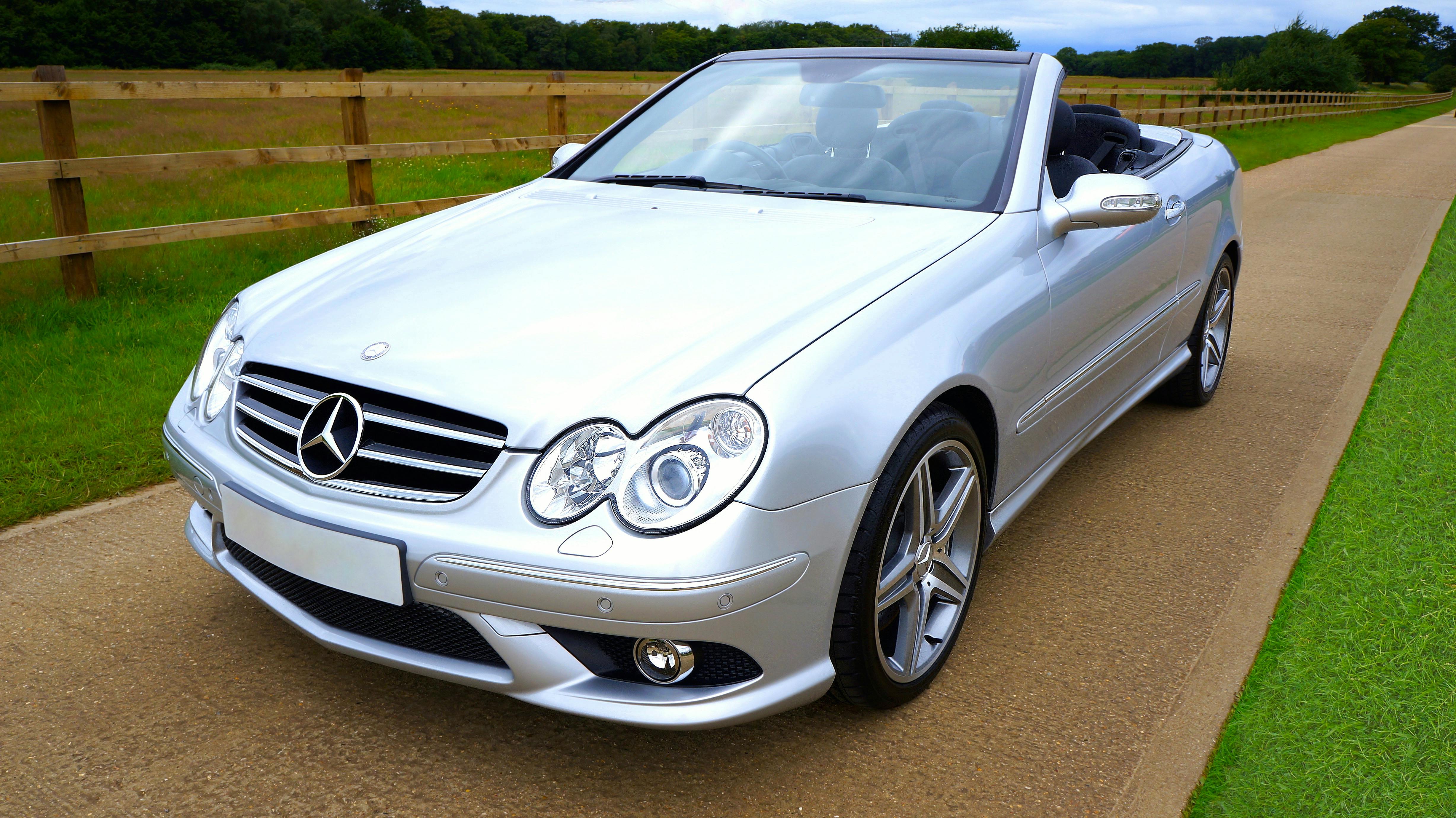 Silver Mercedez Benz Convertible on Brown Concrete Road