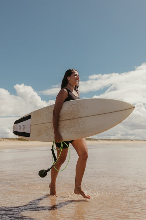 Surfer with a Board Walking Towards the Sea